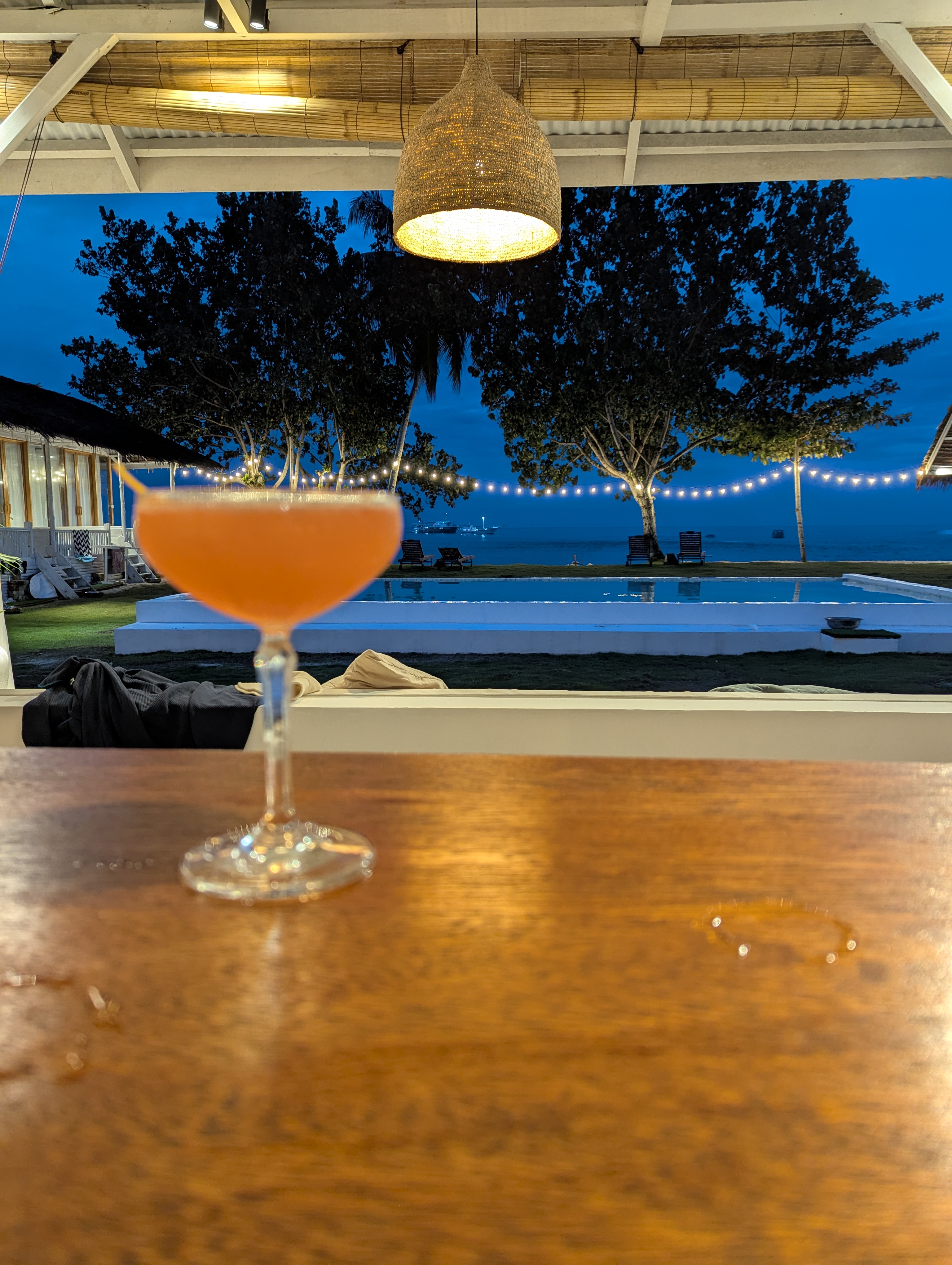 Cocktail at La Belle HTs with pool and ocean view